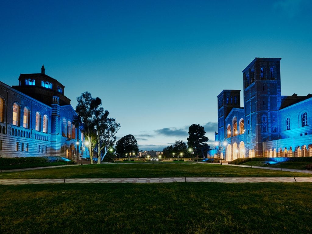 Iconic Powell Library and Royce Hall glow blue at night