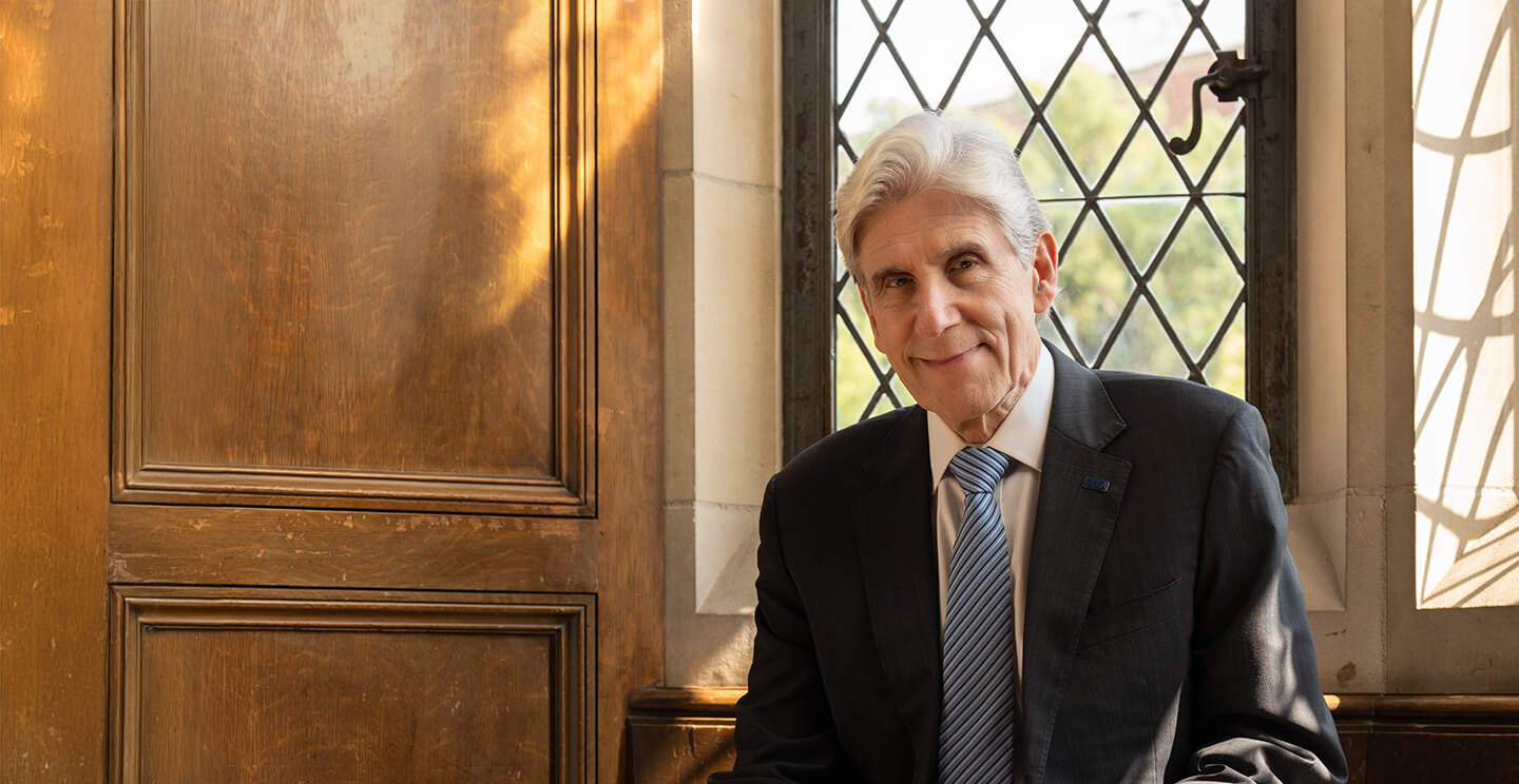 Julio Frenk sitting in front of a window.