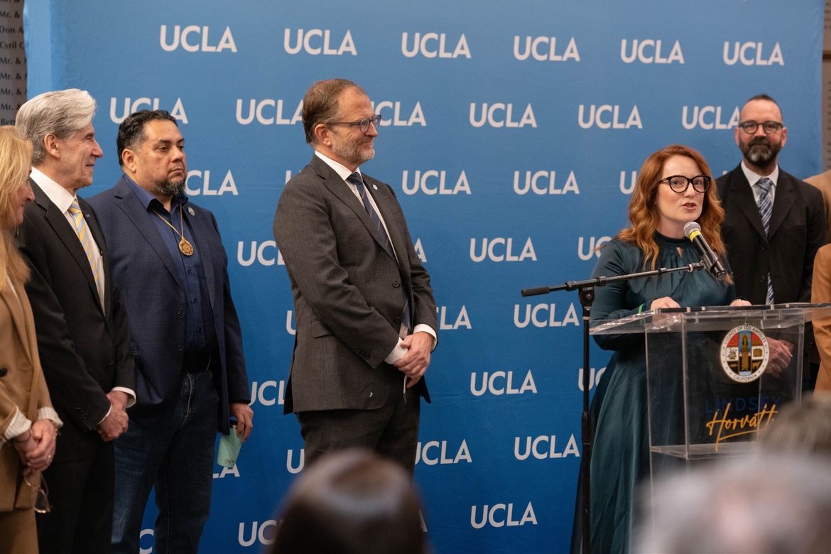 From left: UCLA Chancellor Julio Frenk watches as County Supervisor Lindsey Horvath speaks at a news conference announcing a blue-ribbon commission to inform wildfire recovery recommendations.