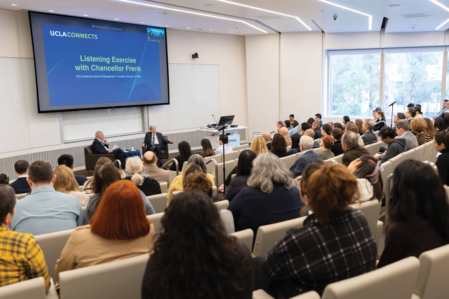 A group of audience listening to Chancellor Frenk in conference room.