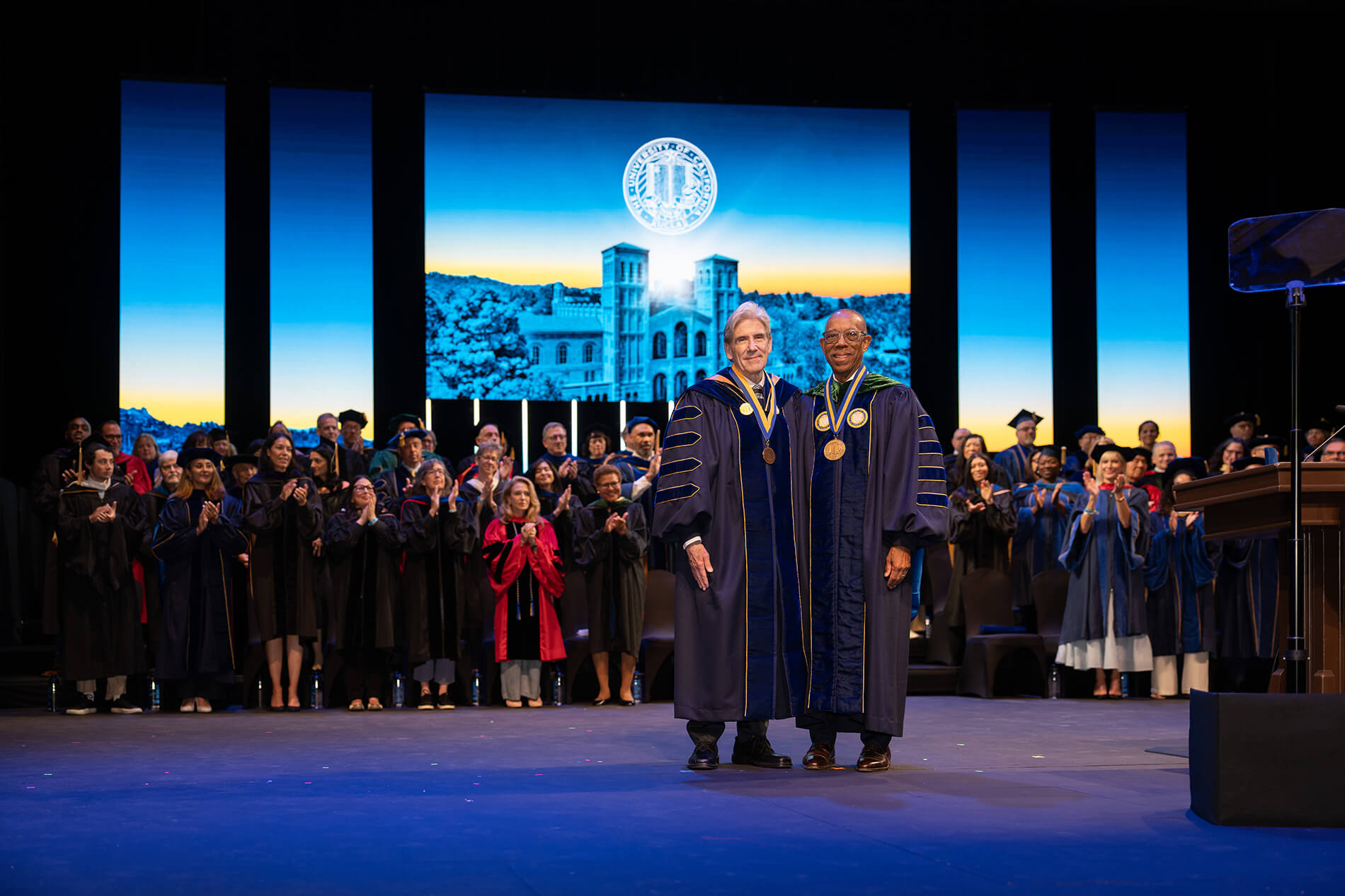 UC President Drake presents Chancellor Frenk with audience standing