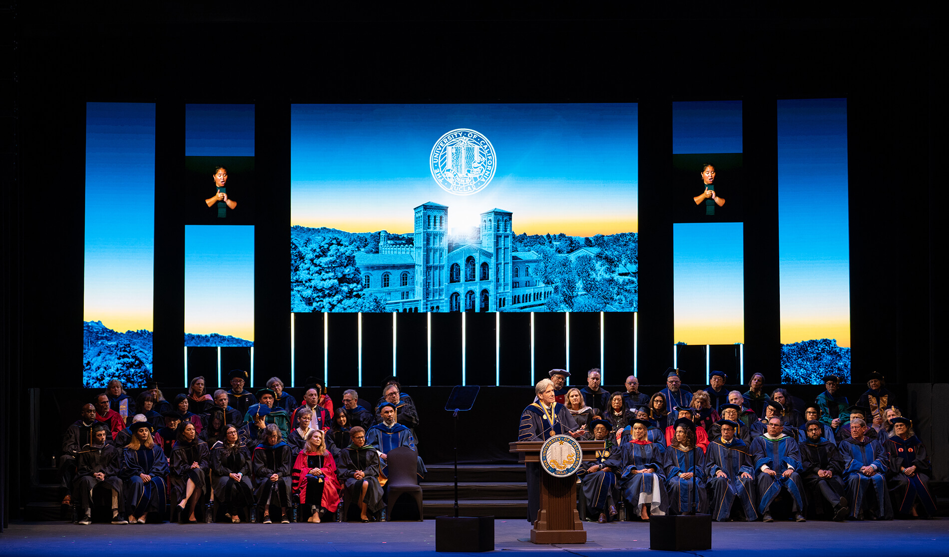 Chancellor Frenk on podium with audience behind him