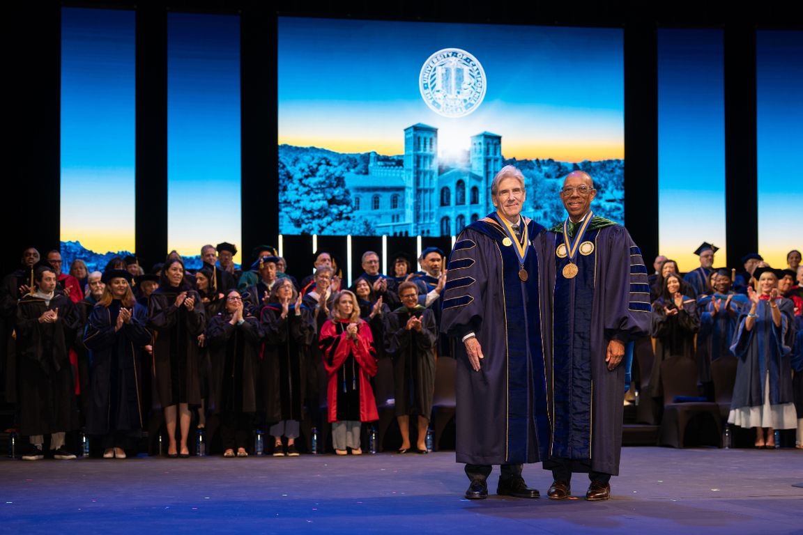 Chancellor Julio Frenk and University of California President Michael Drake meet on stage during Chancellor Frenk's inauguration ceremony in Royce Hall.