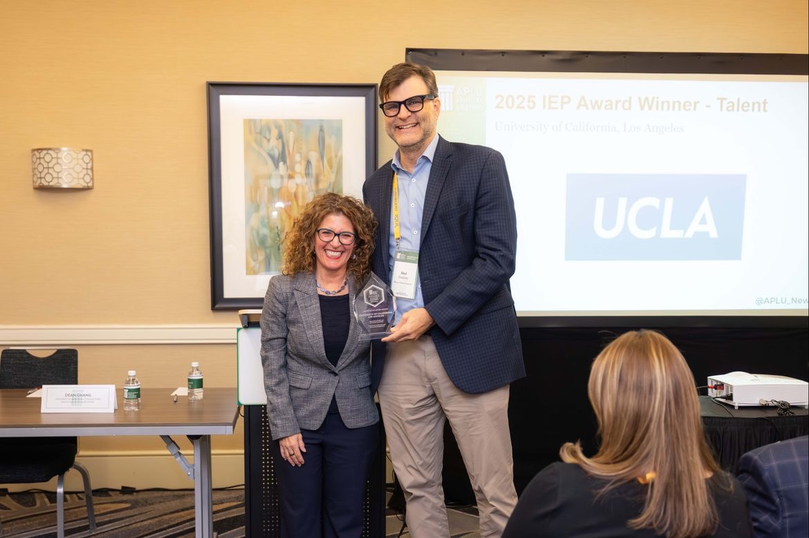 Jennifer Poulakidas, left, in gray jacket and black top, stands next to Ned Staebler in dark blue jacket, light-blue button down and khaki pants