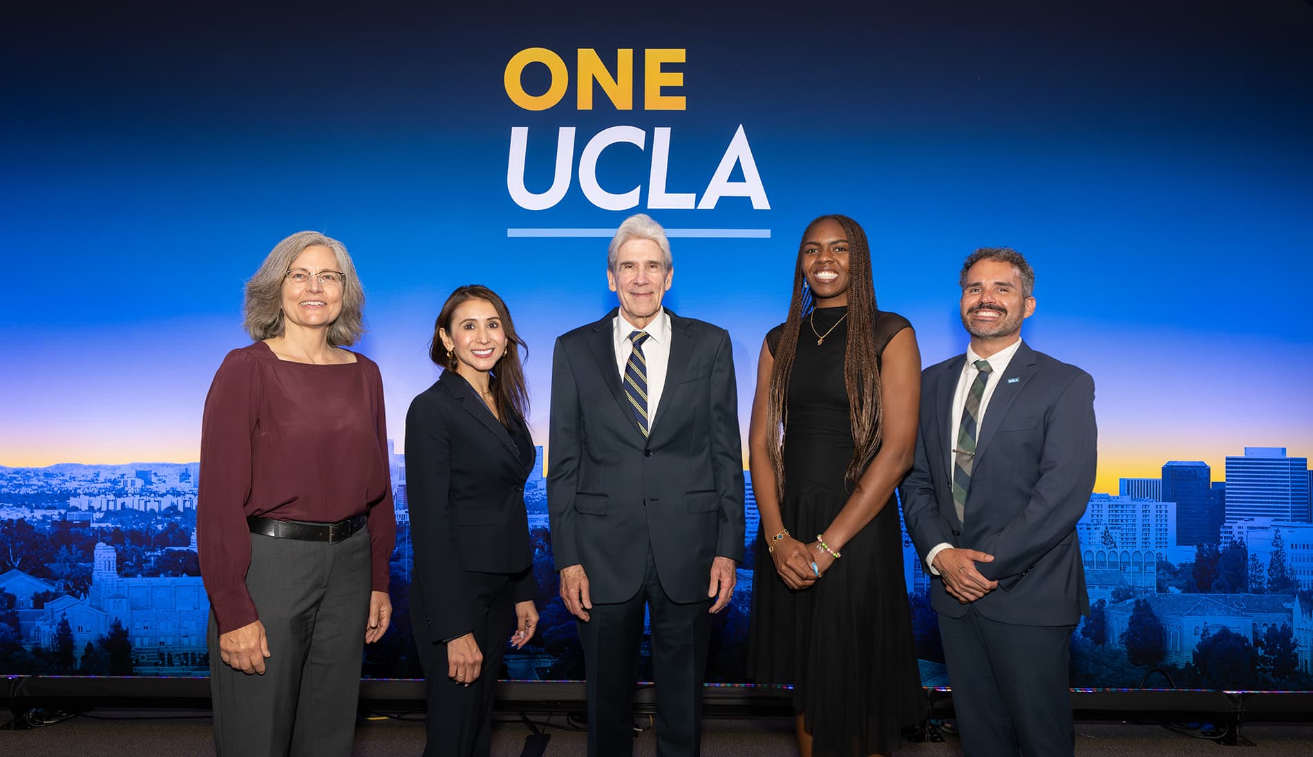 Andrea Ghez, Adriana Galvan, UCLA Chancellor Julio Frenk, Naomi Hammonds, and Michael McCormack standing in front of a One UCLA backdrop.